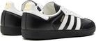 The adidas Samba OG - Men features a black and white leather upper, iconic three stripes, gold Samba lettering, and classic adidas logos—an ideal choice to elevate your street style.