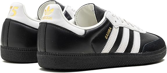 The adidas Samba OG - Men features a black and white leather upper, iconic three stripes, gold Samba lettering, and classic adidas logos—an ideal choice to elevate your street style.