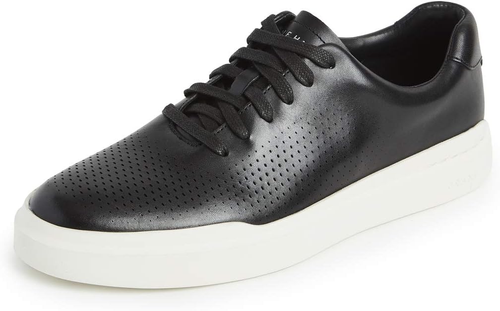 The Cole Haan GrandPro Rally Laser Cut Sneaker for men features a black leather upper with laser-cut perforations, black laces, and a thick white rubber sole.