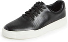 The Cole Haan GrandPro Rally Laser Cut Sneaker for men features a black leather upper with laser-cut perforations, black laces, and a thick white rubber sole.