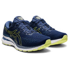 The ASICS Gel Kayano 28 - Mens is a navy blue stability running shoe with lime green accents, white soles, breathable mesh uppers, and cushioned support enhanced by GEL technology.