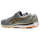The ASICS Gel Kayano 28 - Mens stability running shoes feature a gray upper with orange accents, yellow side stripes, olive green details, white midsoles, and orange outsoles.