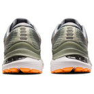 Rear view of a pair of ASICS Gel Kayano 28 - Mens gray and green stability running shoes with orange soles, textured heels, and advanced GEL technology, displayed side by side on a white background.