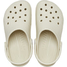 The Crocs Classic Clog - Kids in cream has ventilation holes, textured insoles, adjustable heel straps, and rounded toes for comfort and support. A top view shows these classic kids shoes by Crocs.