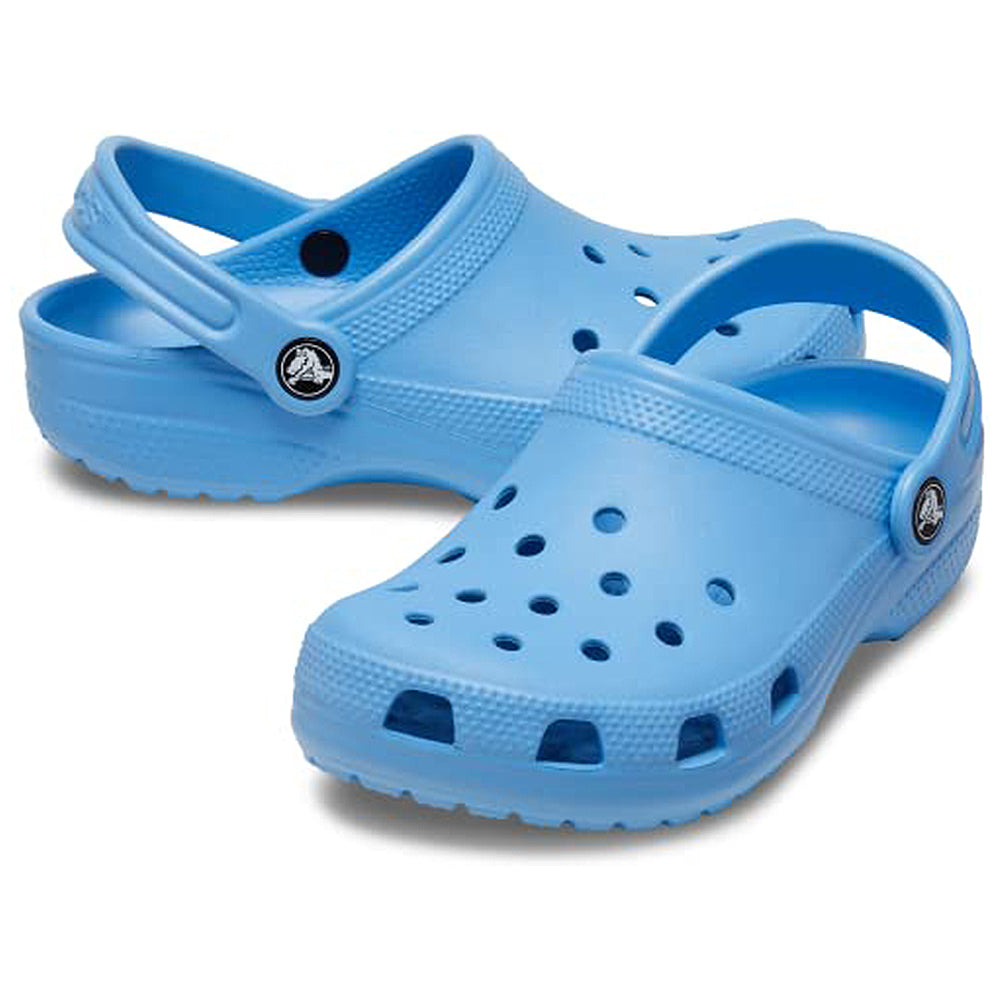 A pair of Crocs Classic Clog - Kids in light blue, featuring holes on top and adjustable heel straps, displayed on a white background.