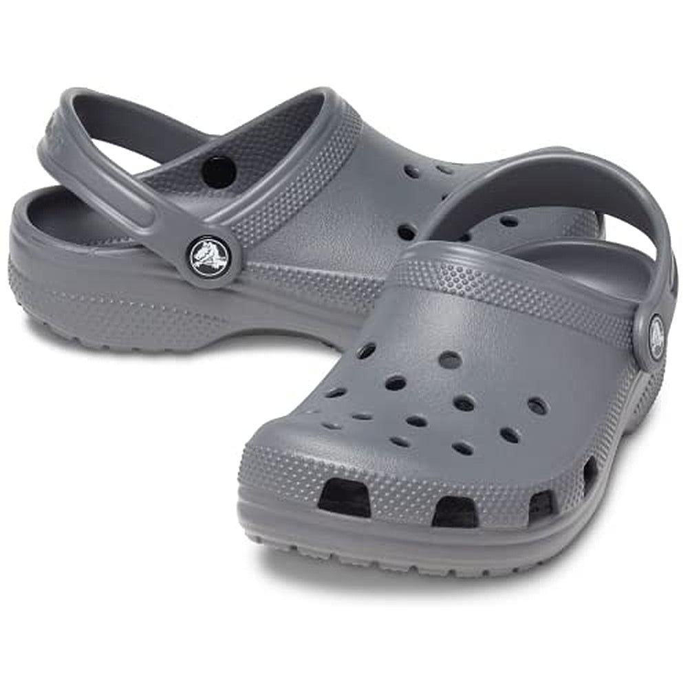 A pair of gray Crocs Classic Clog - Kids shoes with ventilation holes and adjustable heel straps, displayed against a white background.