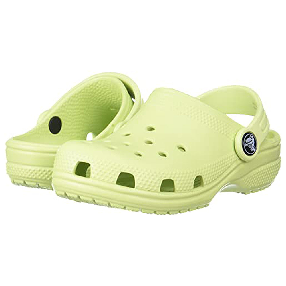 The Classic Clog - Kids by Crocs in light yellow-green features ventilation holes and an adjustable heel strap, shown against a white background.