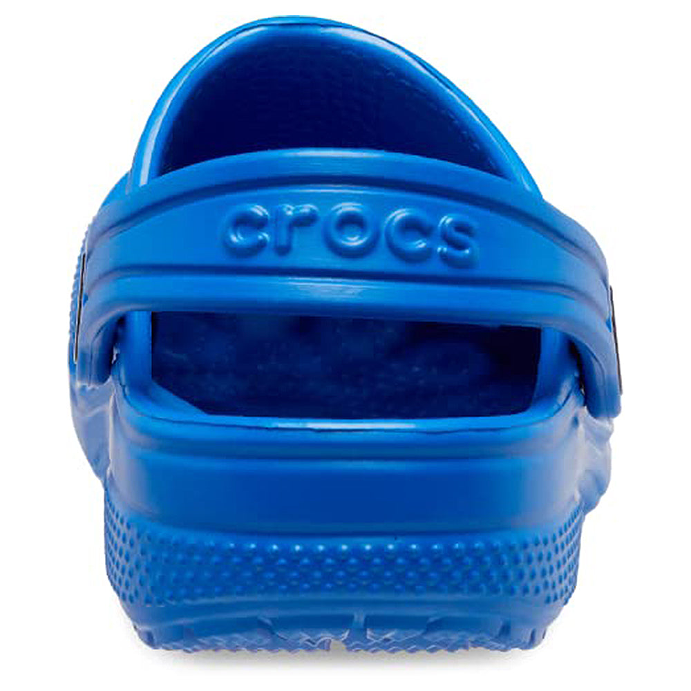 A close-up rear view of the Crocs Classic Clog - Kids in blue, highlighting the heel strap with the embossed CROCS brand name.