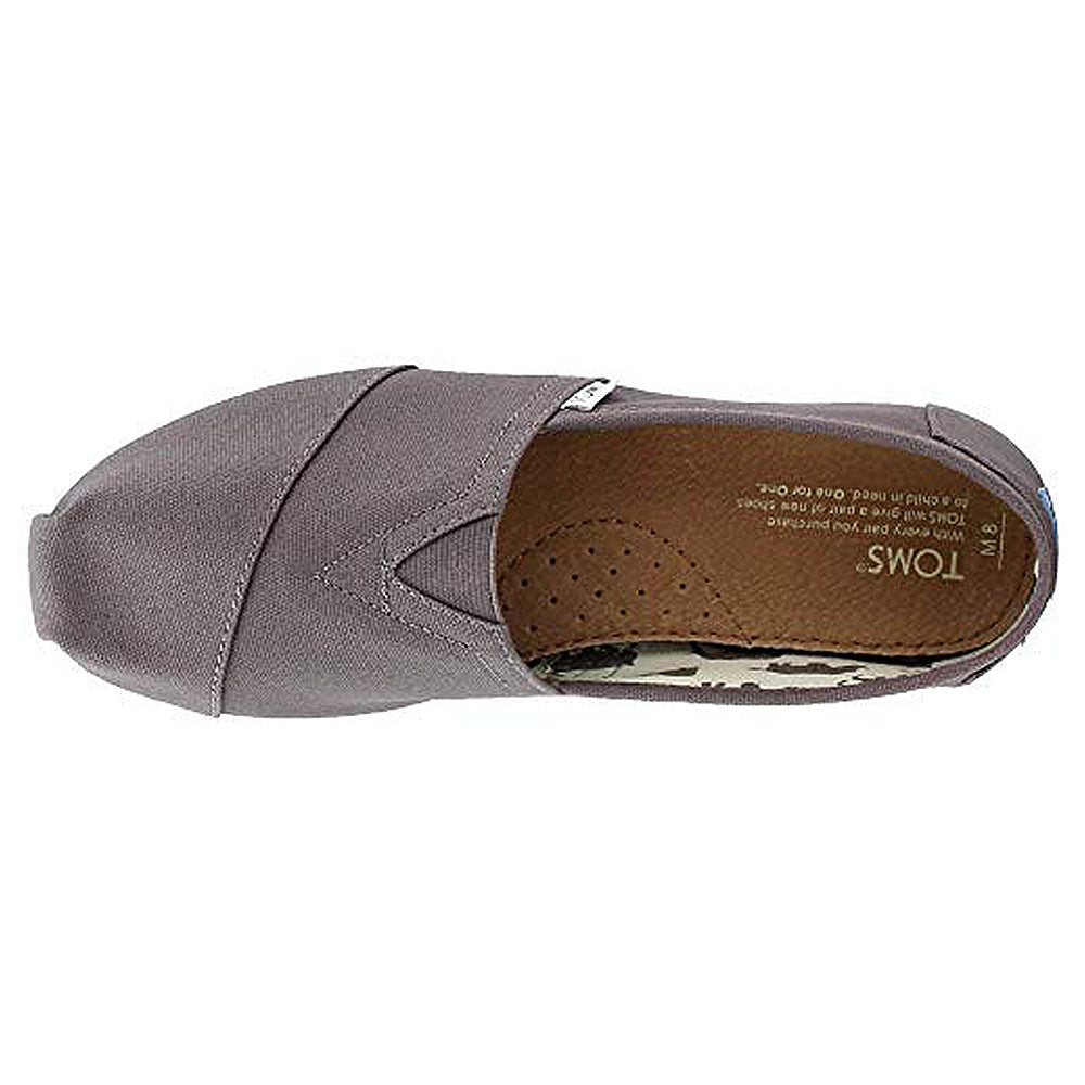 A top view of a single gray TOMS Alpargata ESP - Women slip-on with a canvas upper, tan padded insole, and small TOMS label by the elastic V-insert—showcasing the brands signature buy one give one promise.