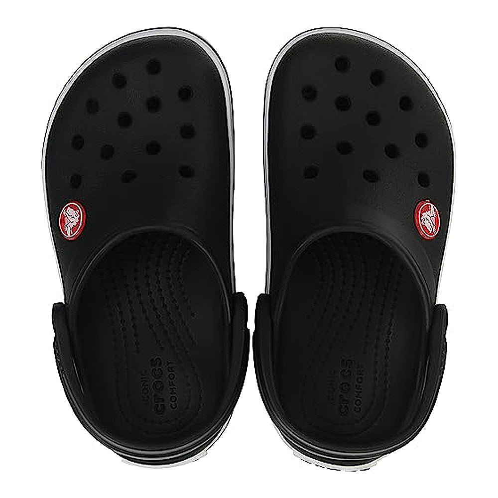 The Crocs CrocBand Clog - Unisex is a pair of black slip-on clogs with ventilation holes, a red-and-white circular logo on the outer side of each shoe, and lightweight Crocs Comfort cushioning.