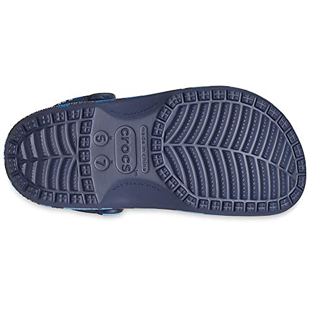 The image shows the sole of a navy blue Crocs Classic Camo Clog - Unisex, featuring a textured tread pattern and sizing details. Designed for comfort by Crocs, these slip-on water shoes are ideal for all-day wear.