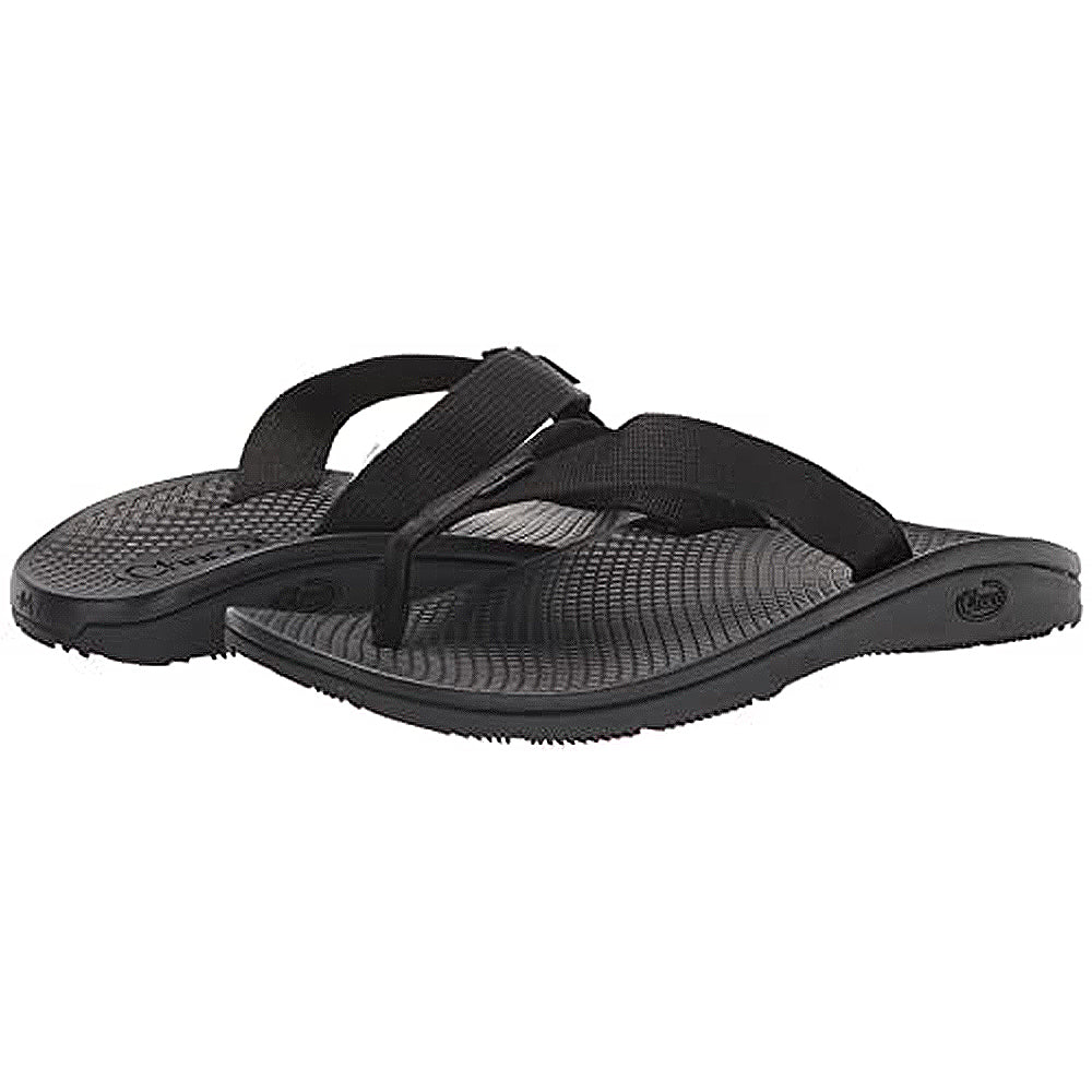 A pair of Chaco Classic Flip - Men sandals with textured rubber ChacoGrip soles and wide black fabric straps, shown angled on a white background.