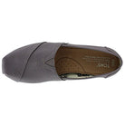 A top view of a single gray TOMS Alpargata ESP slip-on for women, featuring a canvas upper, visible stitching, cushioned insole with the TOMS logo and printed text, and an easy-on slip-on design.