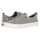 The Sperry Crest Vibe - Womens features light gray canvas uppers, white rubber soles and laces, subtle logo accents on the side and heel tab, durable construction, and arch support—all shown against a white background.