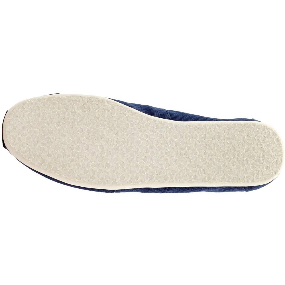 The image shows the bottom view of a TOMS Classic Canvas - Men slip-on in navy blue, featuring a white textured rubber sole with subtle patterns for enhanced grip.