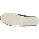 The image shows the bottom view of a TOMS Classic Canvas - Men slip-on in navy blue, featuring a white textured rubber sole with subtle patterns for enhanced grip.