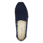 A top view of the TOMS Alpargata ESP - Women slip-on canvas shoe in navy blue, featuring a beige insole with the TOMS logo printed inside and showcasing their signature slip-on design.