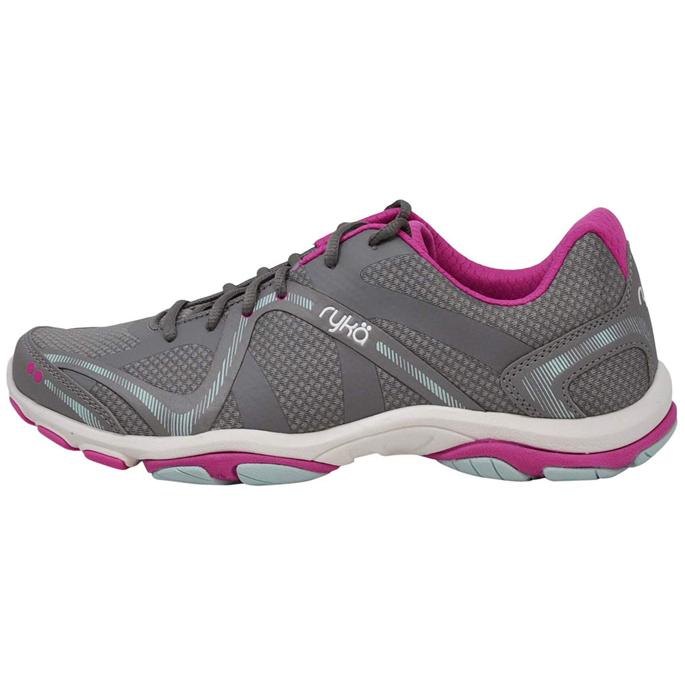 Ryka Influence - Women is a gray athletic sneaker with light blue and pink accents, a pink interior, white sole, and mesh for breathability—ideal for workouts or as a lightweight women’s cross-trainer. Ryka appears on the side.