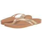 The Reef Cushion Spring Joy womens flip flops feature tan soles, metallic gold straps, and a cushioned footbed for comfort, shown against a white background. Their simple, casual design is ideal for everyday wear.
