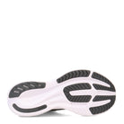 The image shows the sole of the Saucony Ride 15 - Womens running shoe, featuring a white base with black and dark gray rubber tread patterns, plus grooves and textured sections for improved grip, cushion, and flexibility.