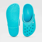 A pair of Crocs Crocband Clog Seasonal Colors - Unisex in bright blue, with one shoe displaying the ventilation holes and the other showing the textured sole, set against a plain light gray background.