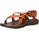The Chaco Z/Cloud - Women in Outskirt Caramel features orange adjustable straps, a dark textured footbed certified by podiatrists, a rubber sole, and the Chaco logo near the heel.
