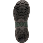 The image shows the treaded sole of The Original Muck Boot Company Apex Mid Zip - Men, a black and dark green boot with deep, rugged patterns for traction and a diamond-shaped logo at the arch.