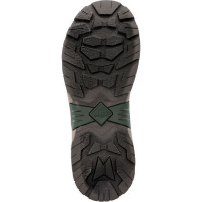 The image shows the treaded sole of The Original Muck Boot Company Apex Mid Zip - Men, a black and dark green boot with deep, rugged patterns for traction and a diamond-shaped logo at the arch.