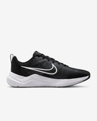 The Nike Downshifter 12 - Women’s running shoe in black, featuring a white swoosh logo and sole, is shown in side profile against a plain white background and delivers lightweight support.