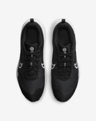 A pair of Nike Downshifter 12 - Women black running shoes with white soles and swoosh logos, designed for lightweight support, shown from above on a white background.