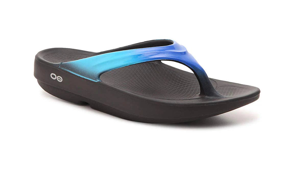 The OOFOS OOlala Sandal - Unisex in Black/Bluejay features a thick wedge sole, blue gradient strap, and OOfoam technology for superior recovery, shown on a white background.