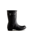 The Hunter Original Short Rain Boots for women feature a black rubber, mid-calf design with side buckle and textured sole, shown in profile against a white background—ideal festival boots for rainy days.