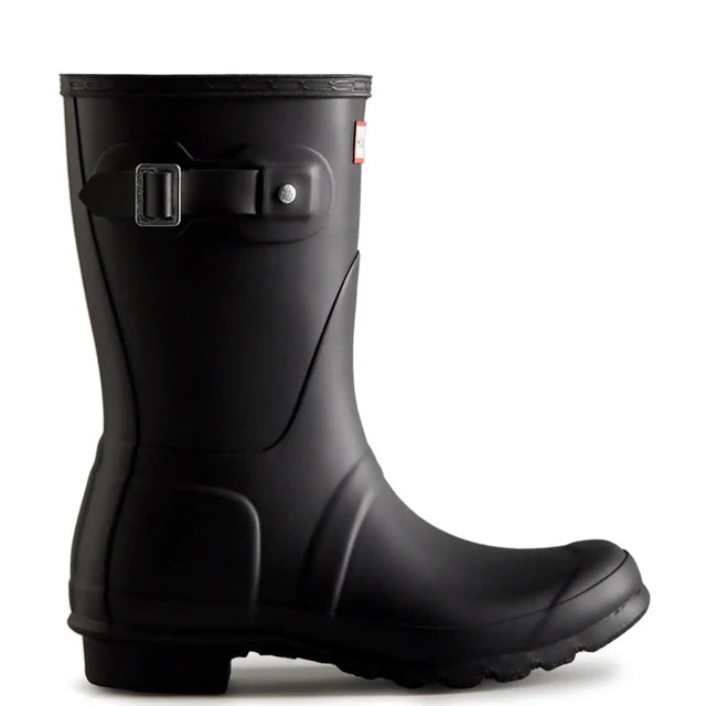 A single Hunter Original Short Rain Boot for women in black, featuring a low heel and decorative side buckle, pictured in profile with the toe pointing right.