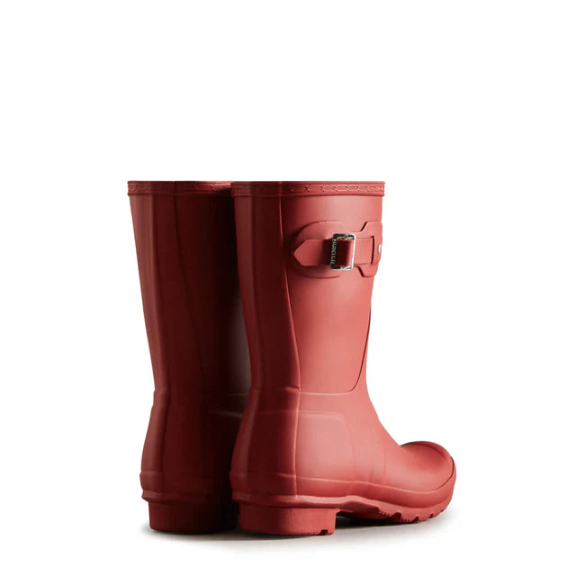 The Hunter Original Short Rain Boots for women, in red with a side buckle, are shown from the back and side on a white background—ideal as stylish festival boots or waterproof rainwear.