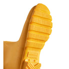 Close-up of the yellow sole on Hunter’s Original Short Rain Boots for women, featuring detailed tread patterns and the HUNTER logo embossed near the heel.